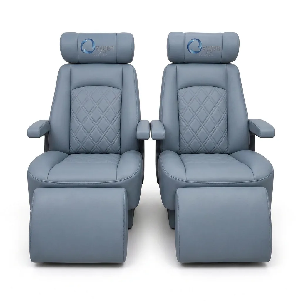Pair of powder gray quilted leather recliners with Oxygen Health Systems headrests and extended footrests, diamond-stitched backrests and padded armrests